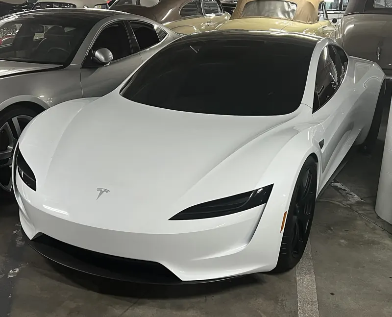White second-generation Roadster prototype parked among other cars at the Petersen Automotive Museum